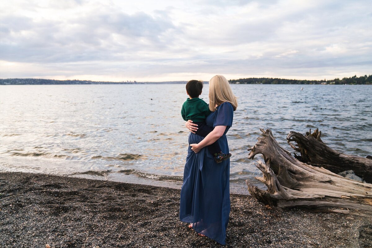 Mother and son admiring the water during Mercer Island maternity photoshoot