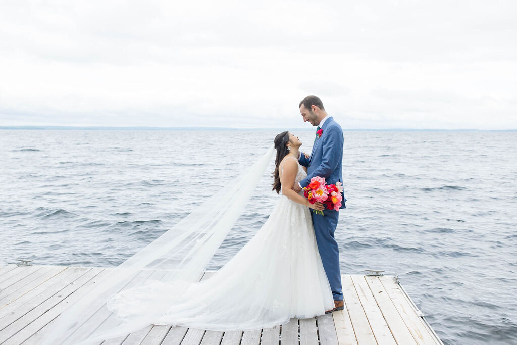 Maine couple standing on dock near water