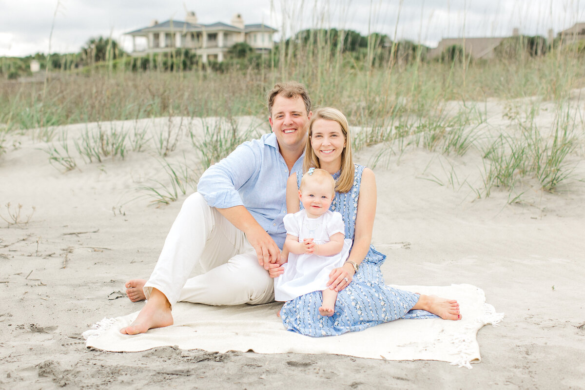 New parents with baby pose on Charleston beach by Karen Schanely Photography