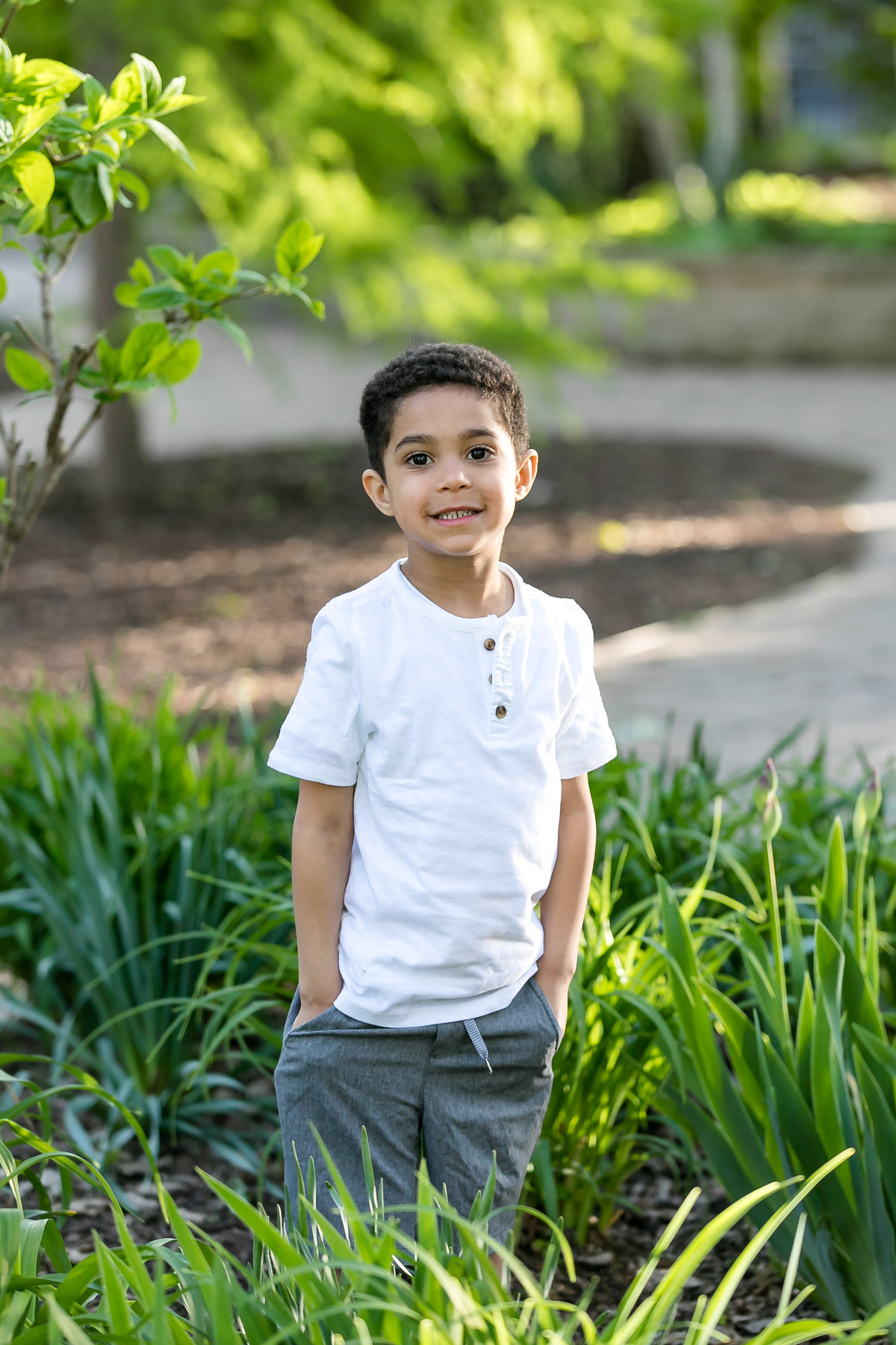 little boy standing in the park for his 5 year old pictures