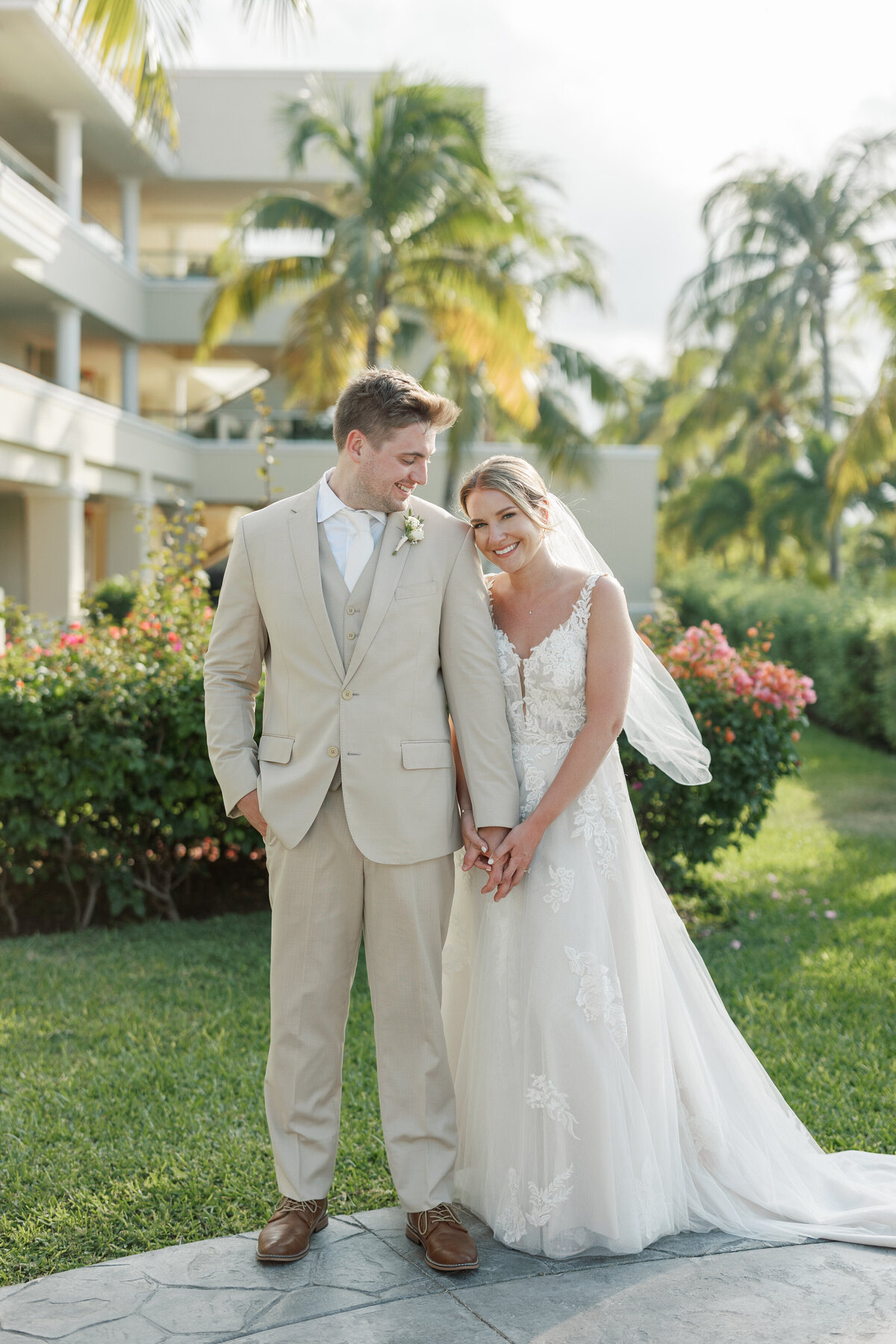 Bride and groom pose outside Cancun resort, photo by Philadelphia wedding photographer.