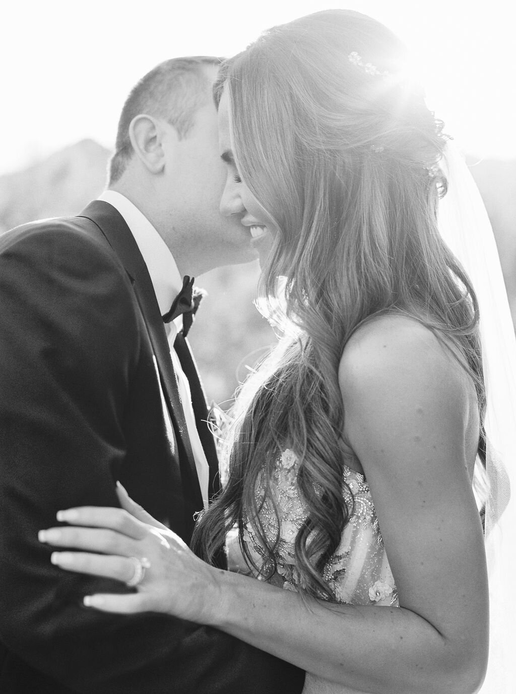 A stunning golden-hour portrait of the bride and groom sharing a quiet, intimate moment, glowing with love and happiness.