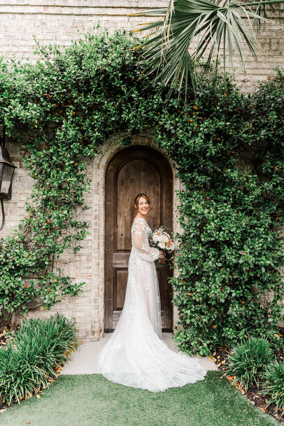 bride standing in front of a beautiful door at wrightsville manor in wilmington, nc