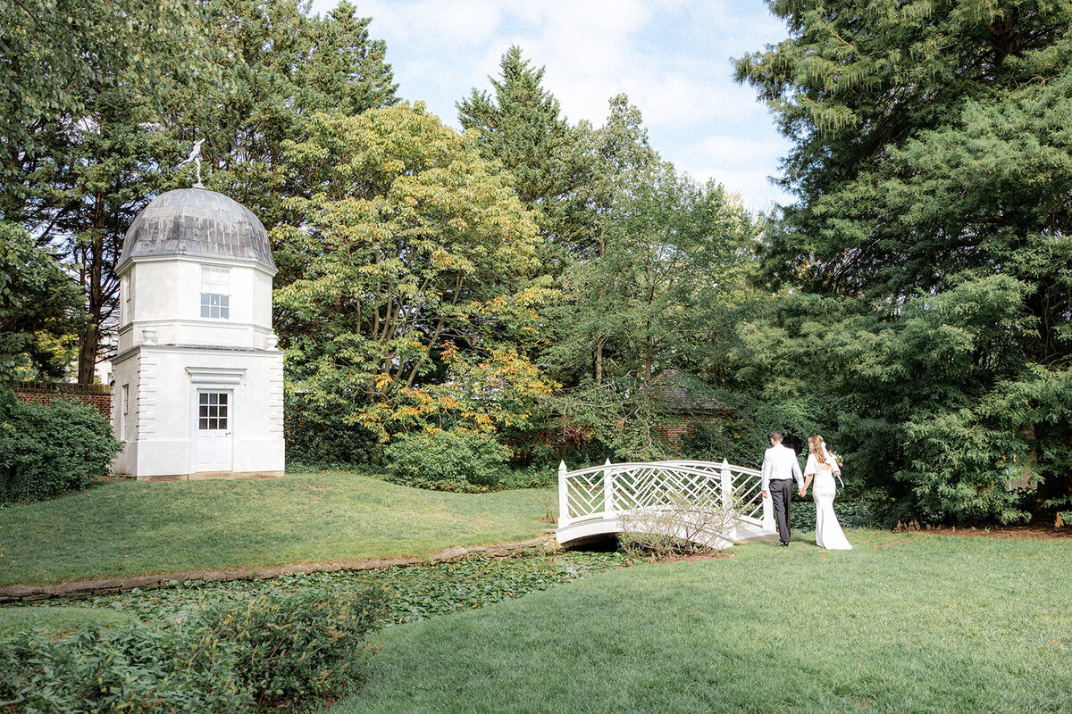 Bride and groom walking across bridge