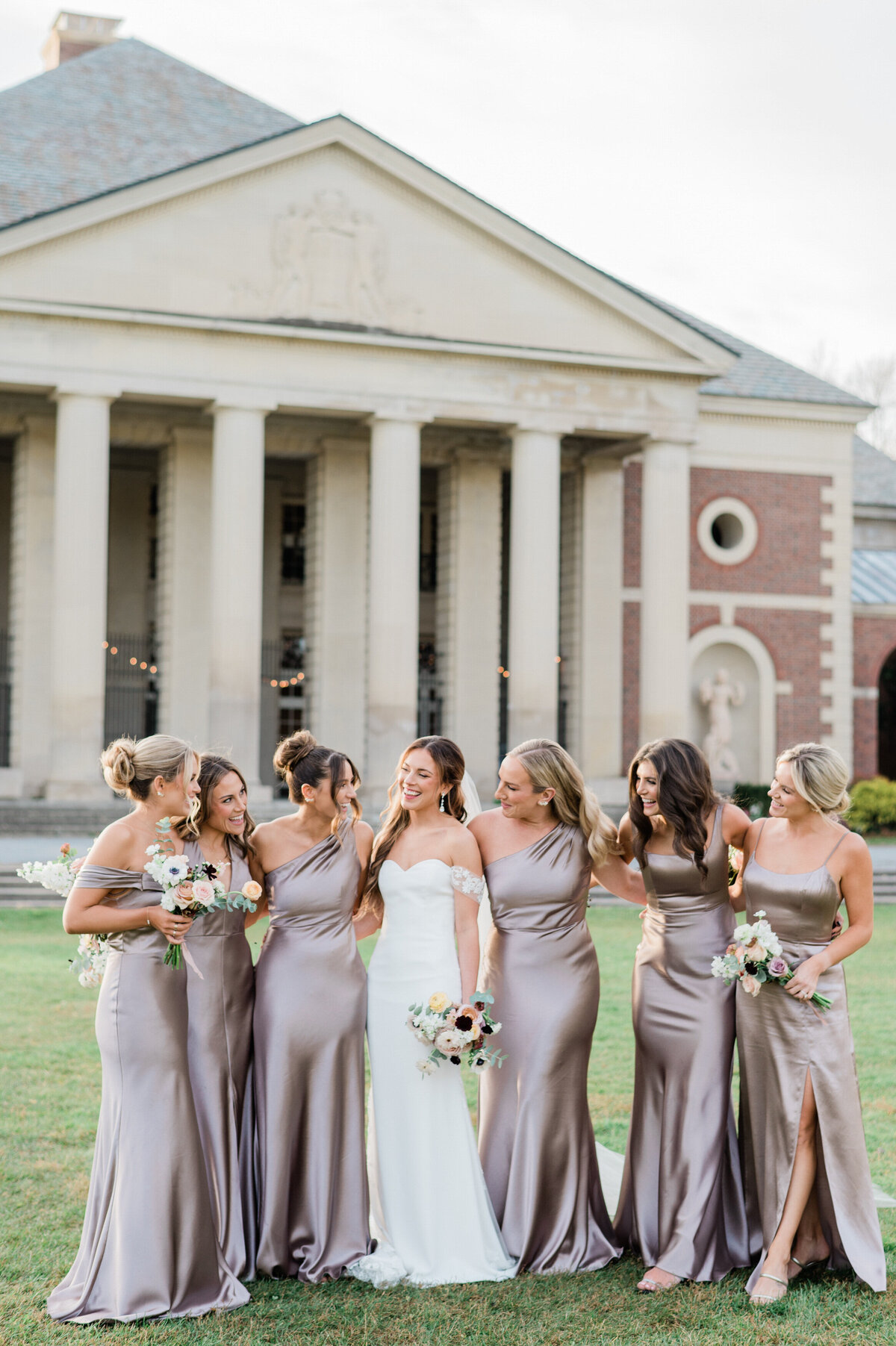 Bridesmaids stand next to bride outside a DC building 