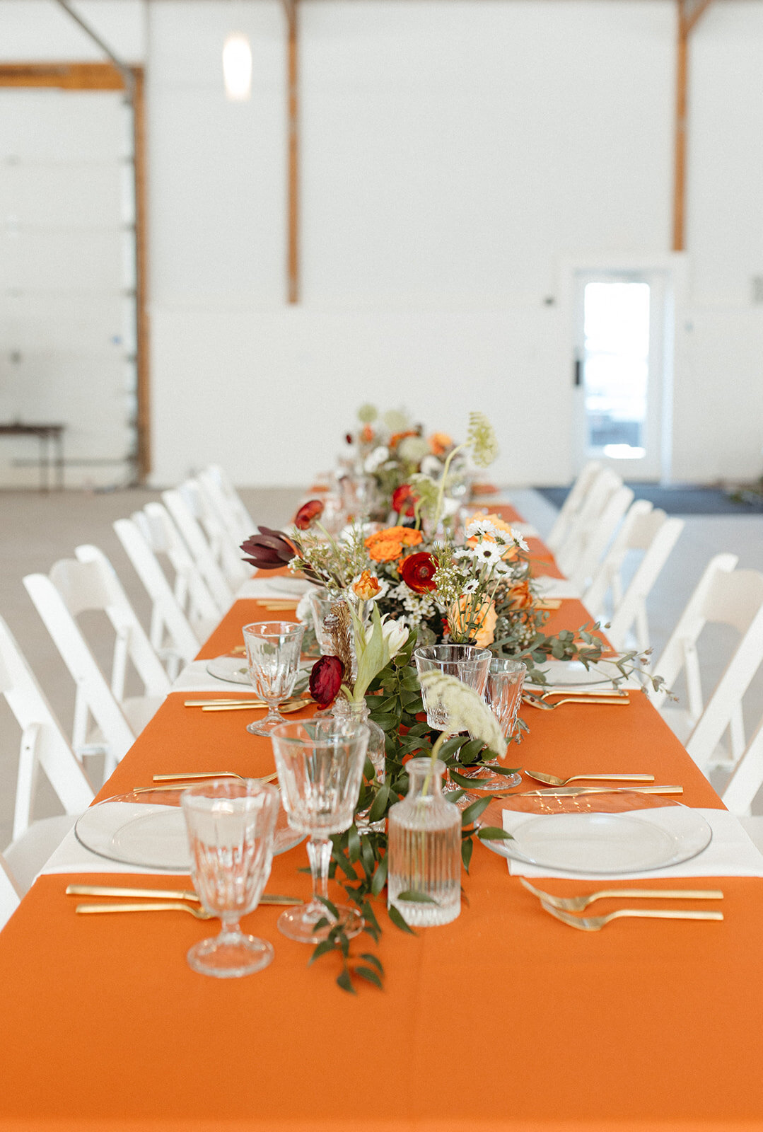 Orange wedding table at Wild Rye KC