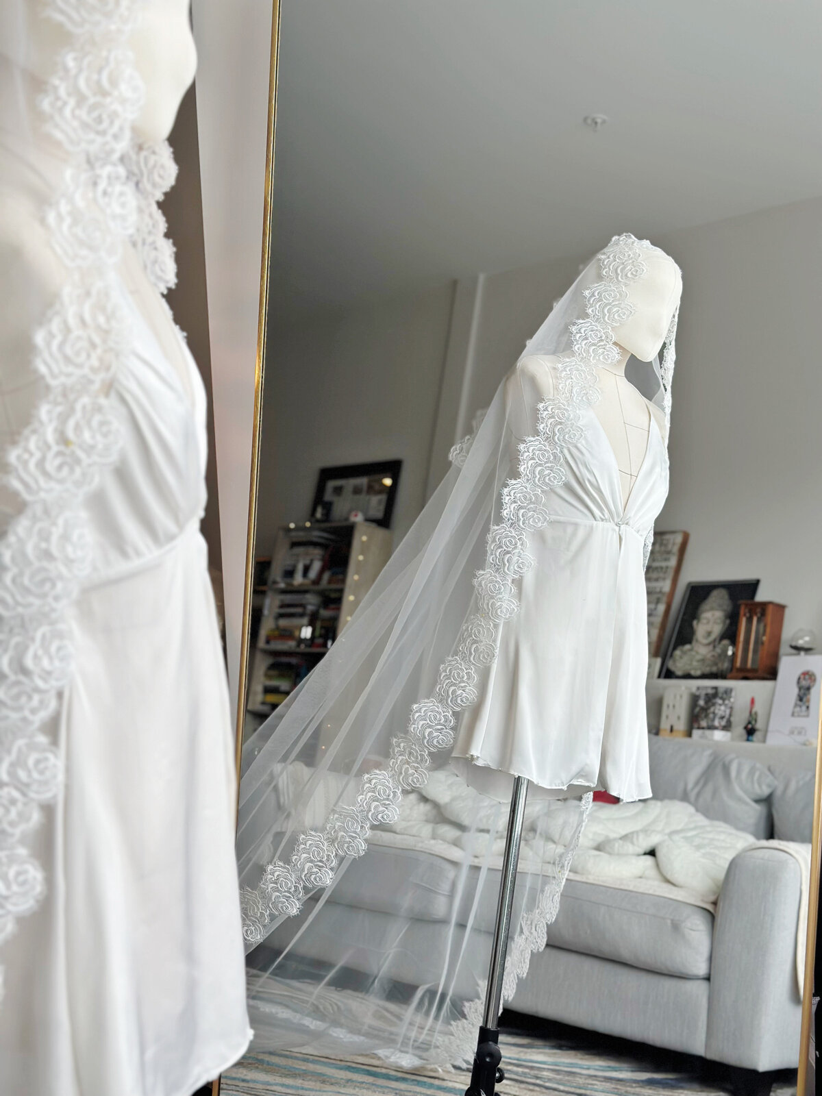 Cathedral-length mantilla veil flowing softly behind the bride