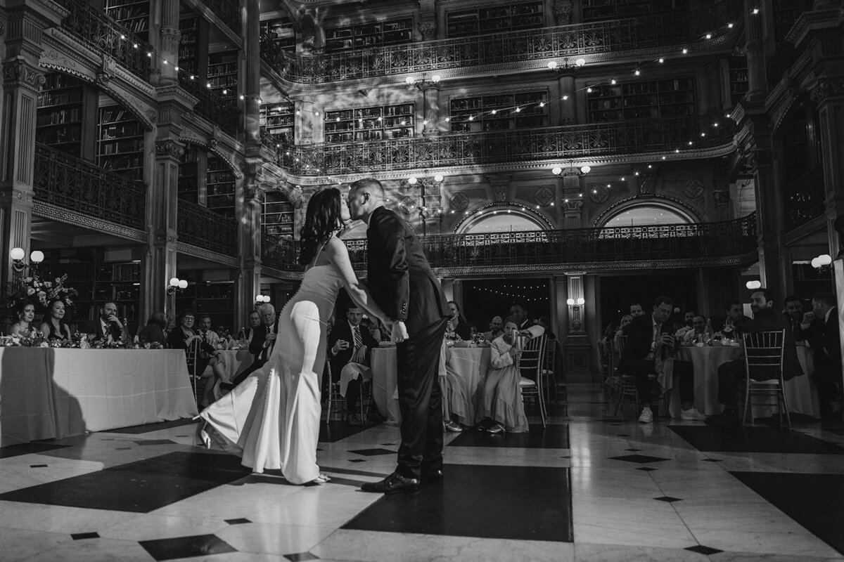 Newlyweds kissing on the dance floor at their reception 