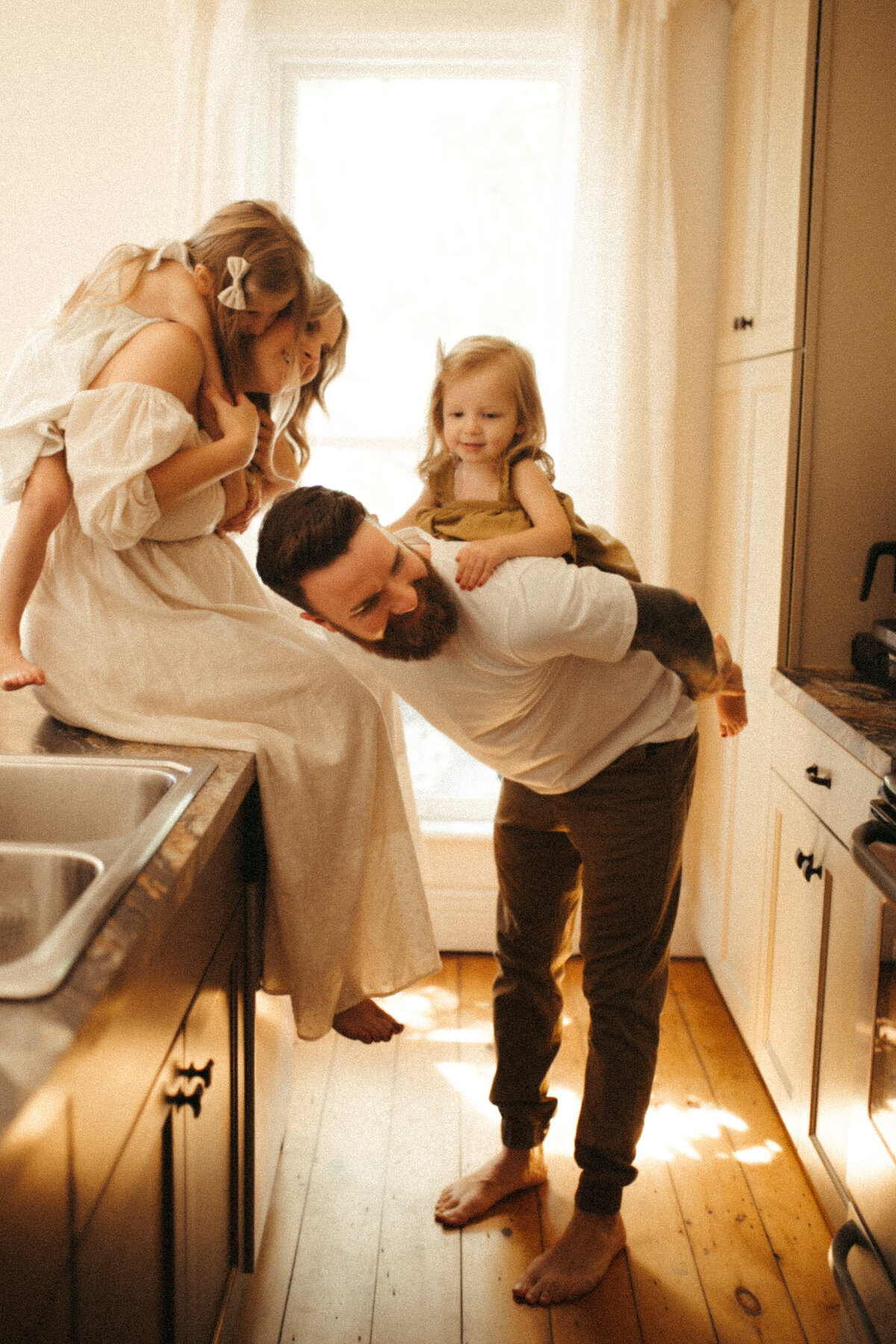 mother and father in kitchen with children