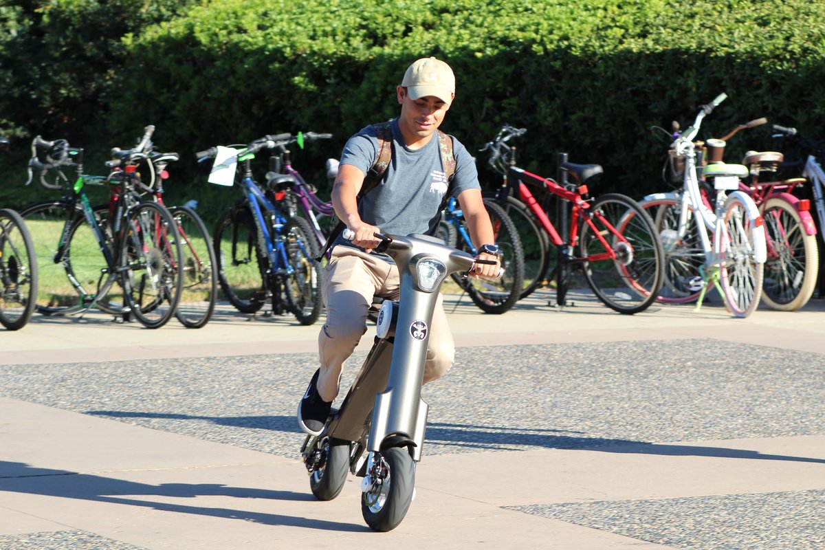 Student riding Charcoal Go-Bike M1
