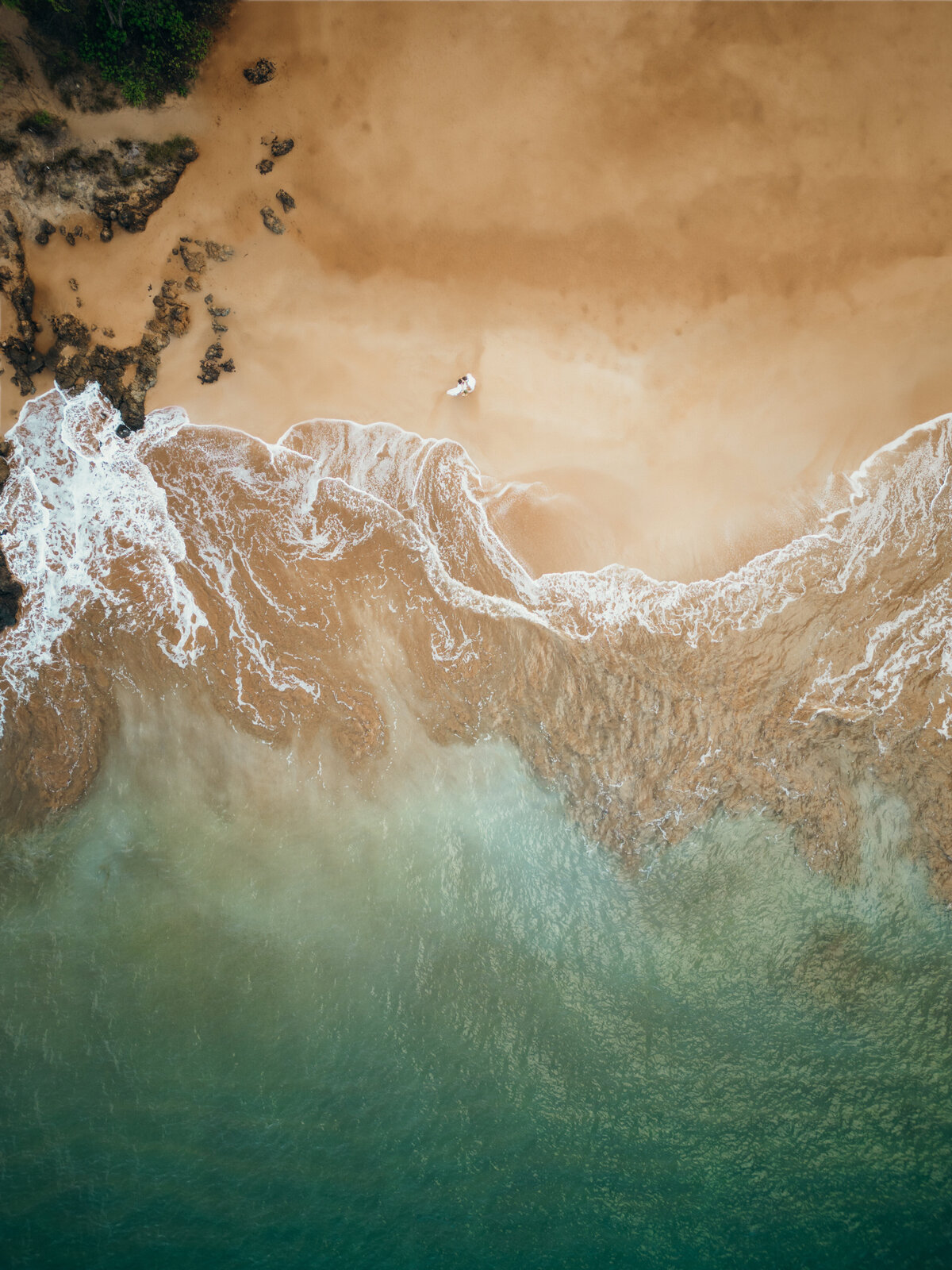 Maui Wedding Photographer captures bride and groom walking on beach with overhead drone shot