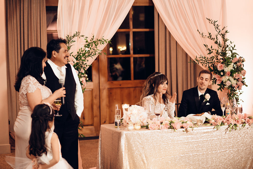 Wedding Photograph Of Woman In Dress Speaking In Microphone In Front Of Bride And Groom Los Angeles