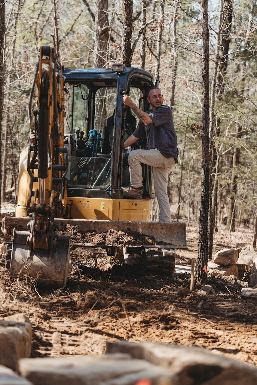 mini-excavator-clearing-wooded-property-better-lawns
