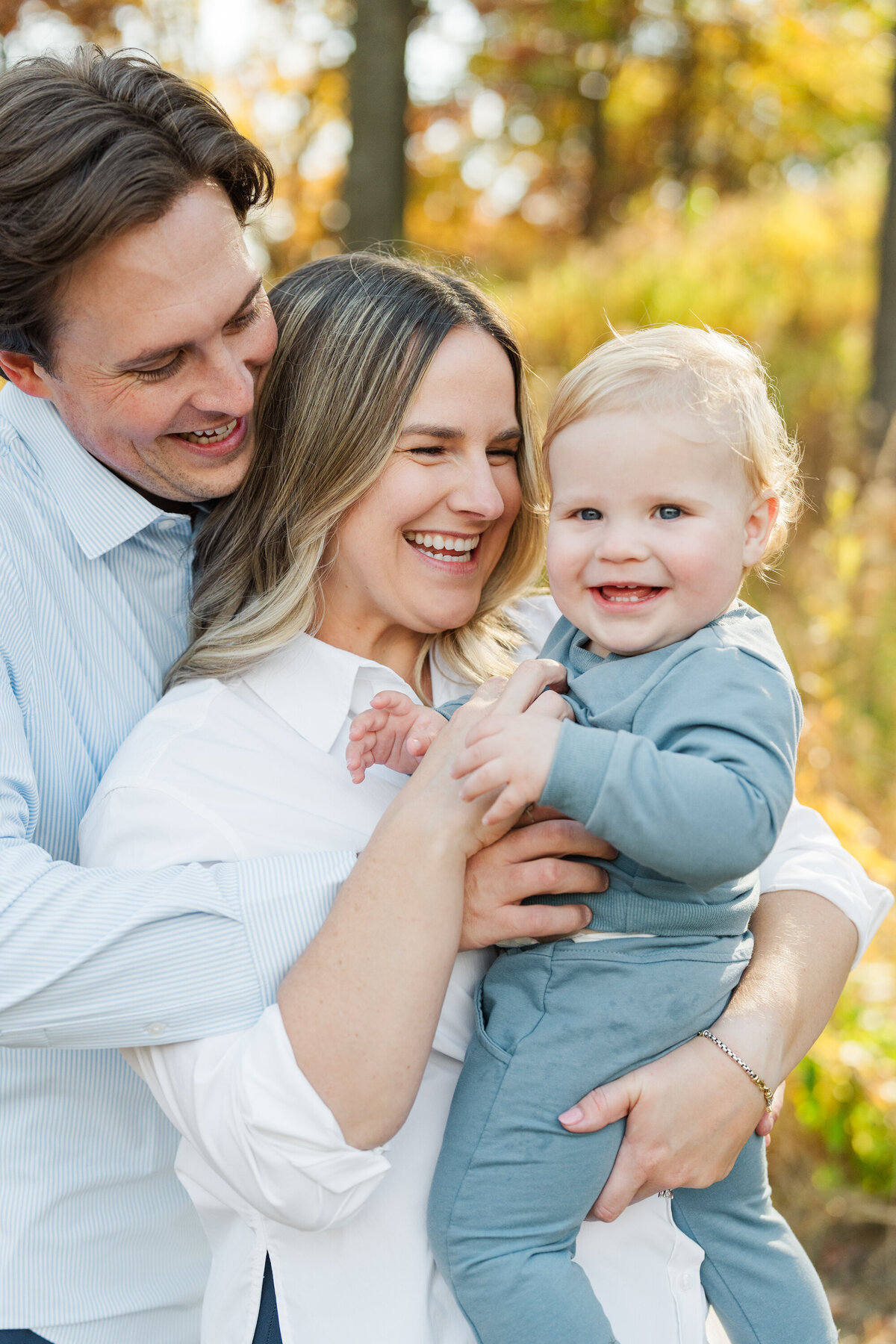 Beautiful family of three in a beautiful fall setting by Minneapolis Family Photographers