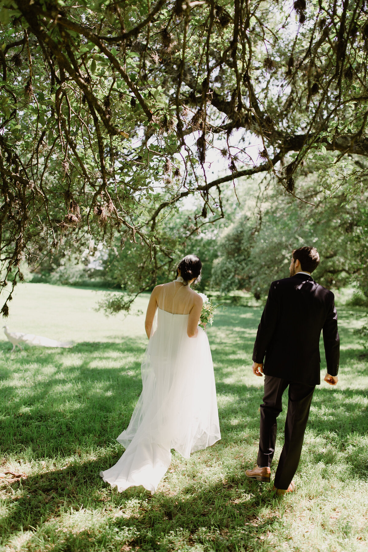 Bride and groom walking along in the grounds of Mattie's  Austin Wedding