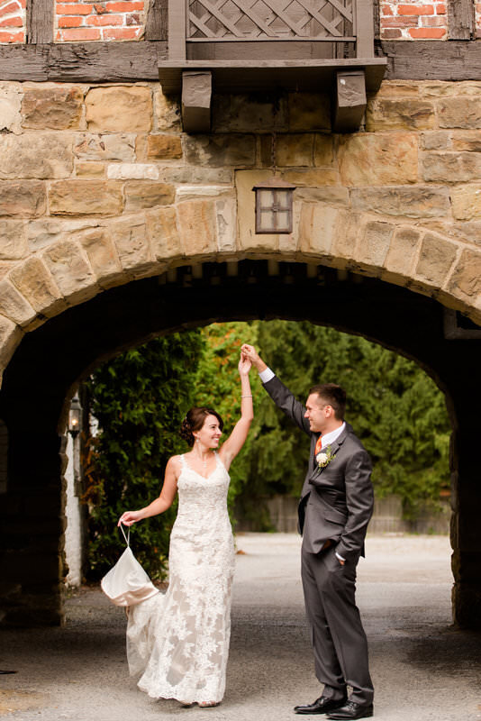 groom giving the bride a twirl in the valet area of the Hyeholde restaurant