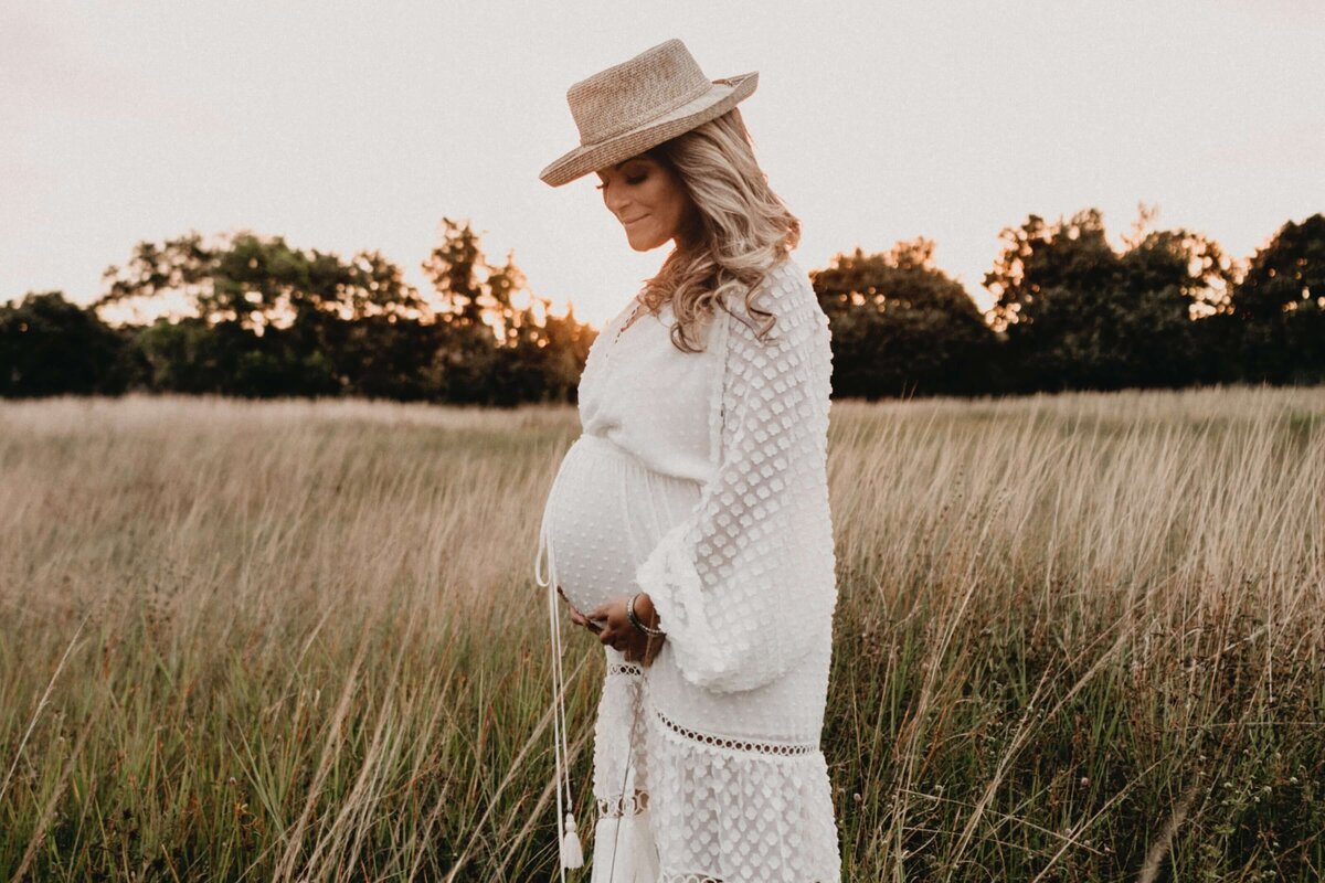 Photo Of Pregnant Woman Standing On Field