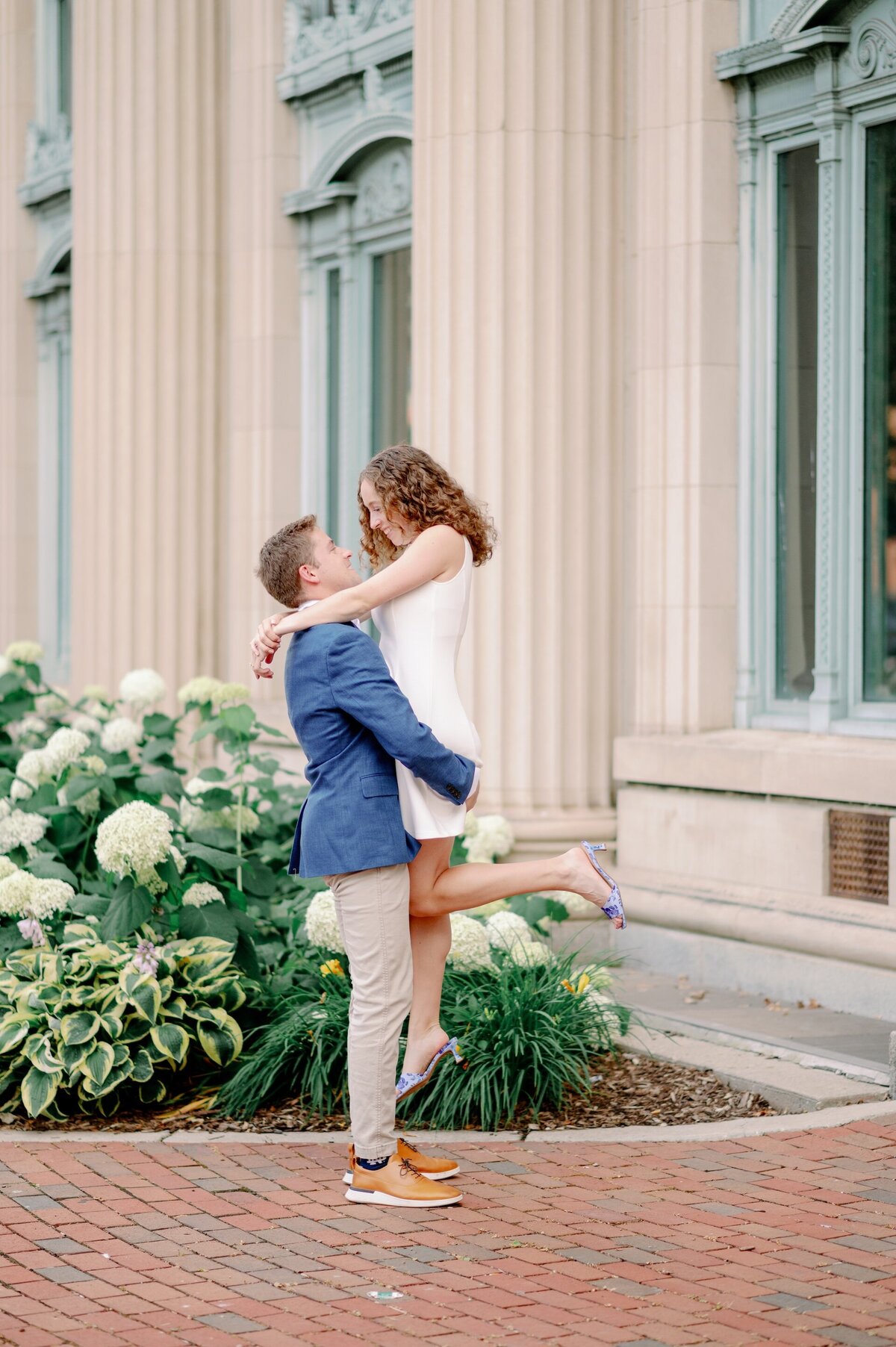 man lifting his fiance in the air