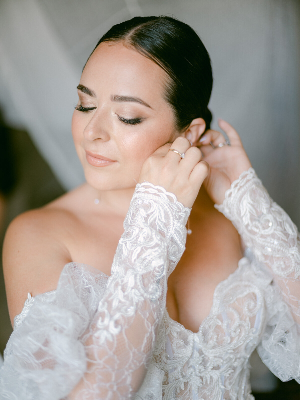 Bride getting ready on her wedding day in Italy – elegant bridal portrait with lace gown and timeless makeup.