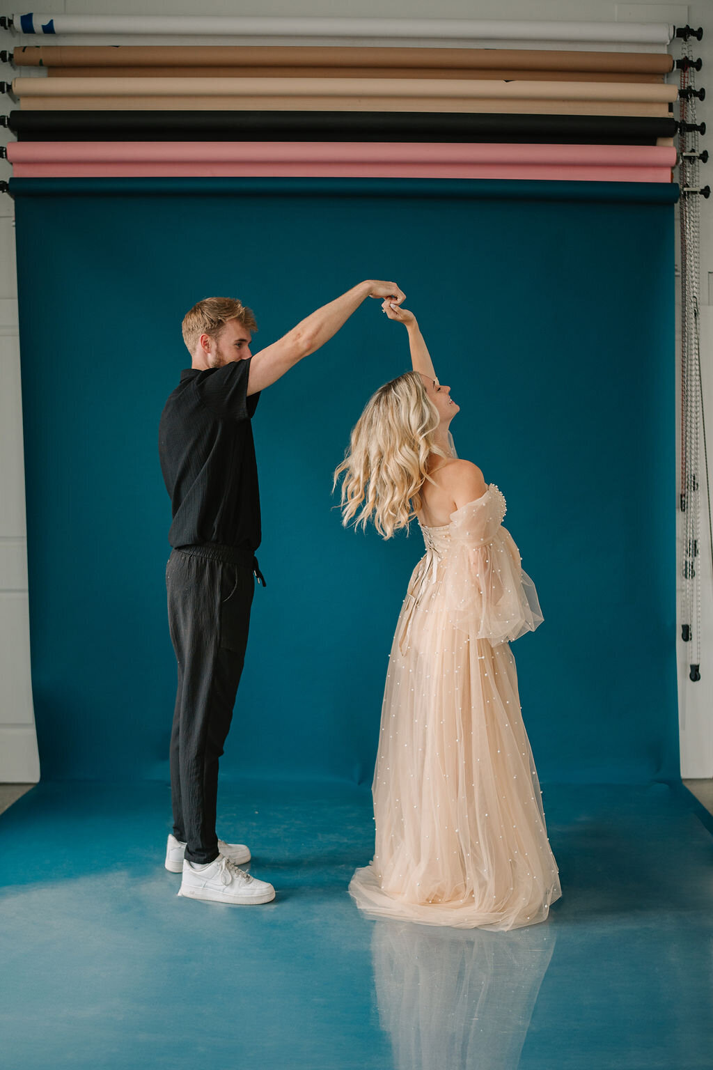 A person twirling their pregnant partner 