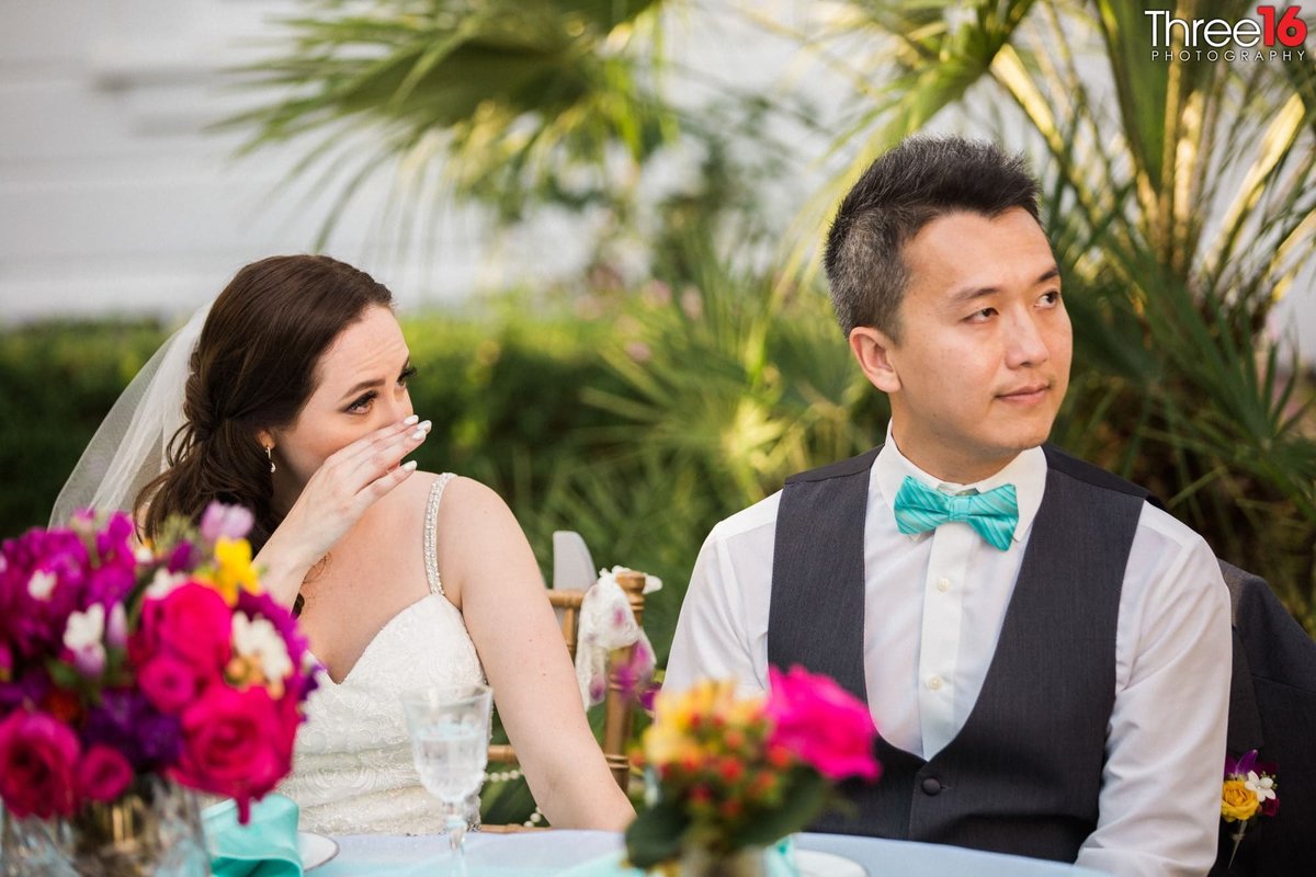 Newly married couple sheds a tear during the toast