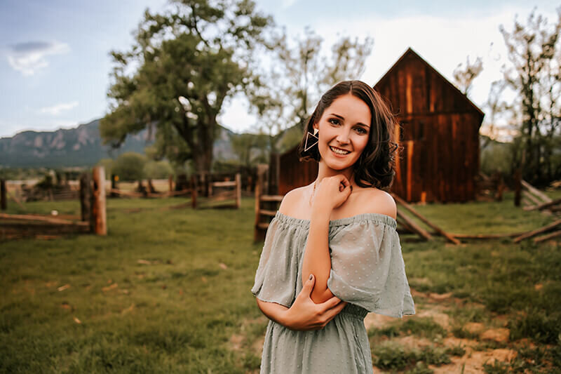 Mom poses for her own photo in shoulder less green dress