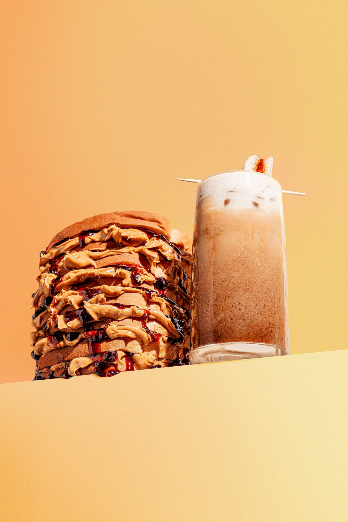 Food product photography in Columbia, SC featuring a tall Peanut butter and jelly sandwich and latte
