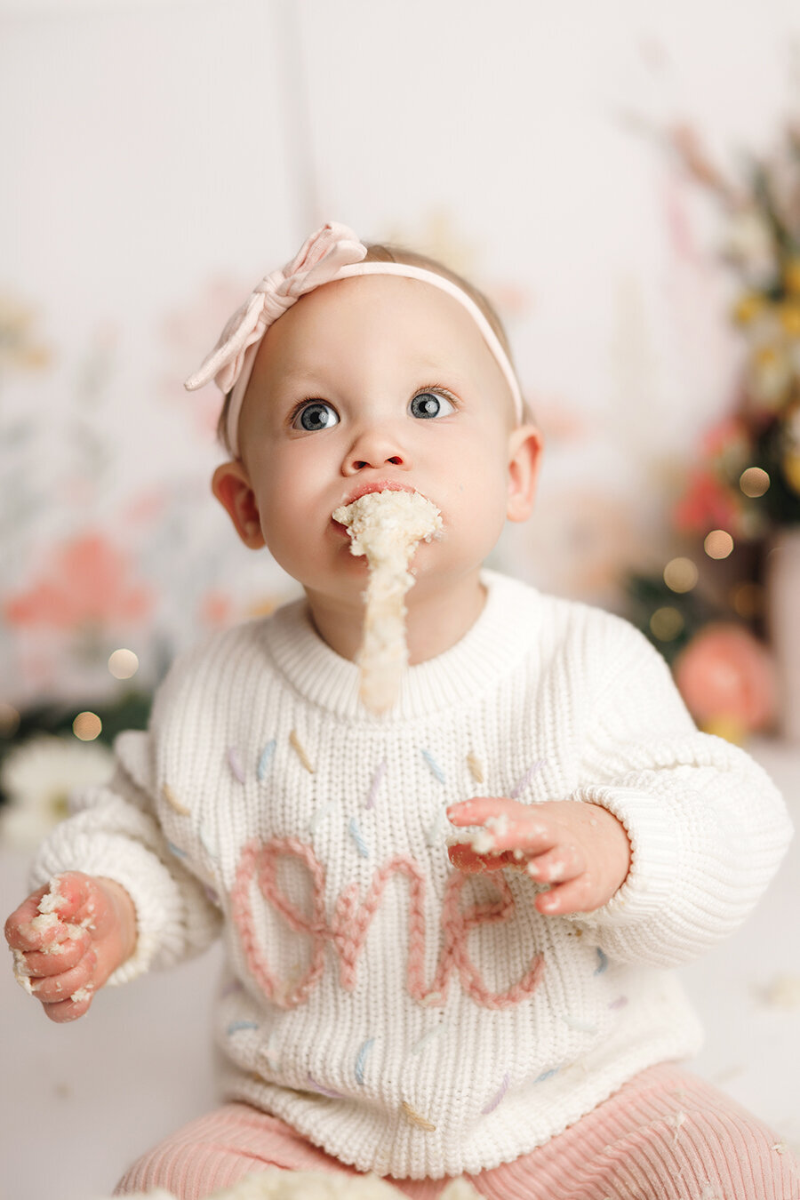 Hilarious one year old baby girl being funny at her cake smash session