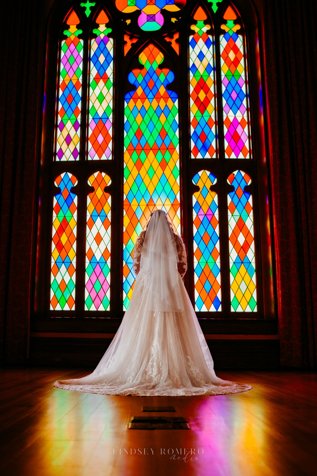 bridal photo with lace dress and stained glass at old state capital in baton rouge, la