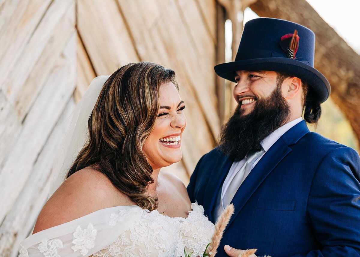 Bride and groom laughing at the altar, in outside wedding