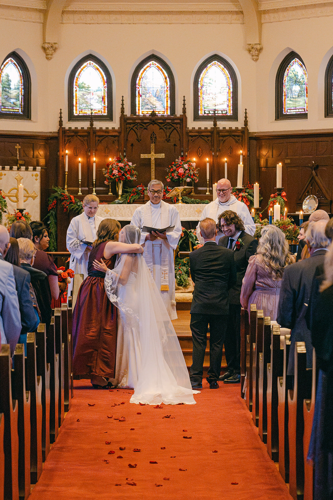 A sentimental moment between the mother and father of the bride as they give the bride away during a San Antonio Luxury Church Wedding
