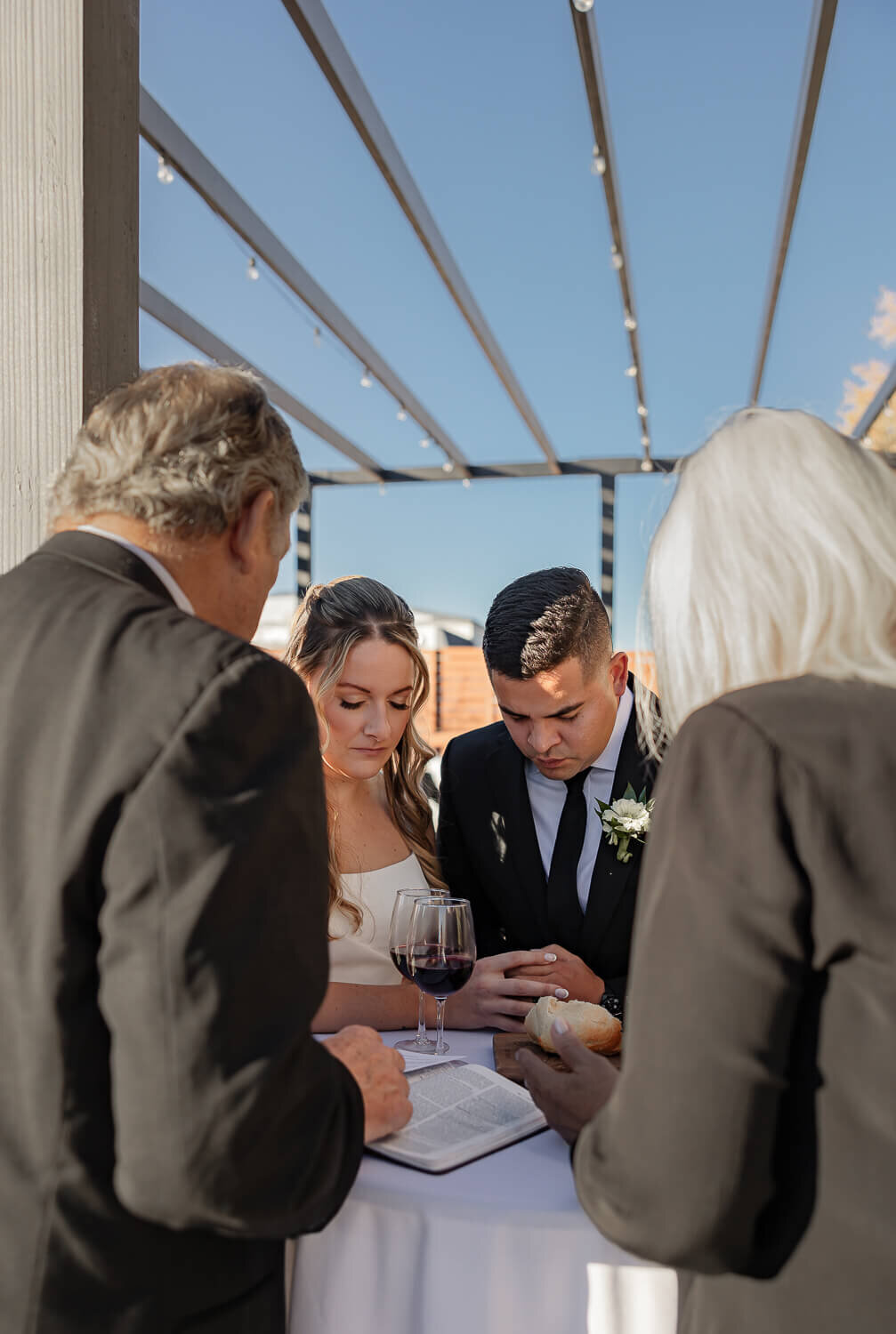 Elegant outdoor wedding ceremony, bride and groom doing communion in Colorado Springs, photographed by Michelle Betz Photography