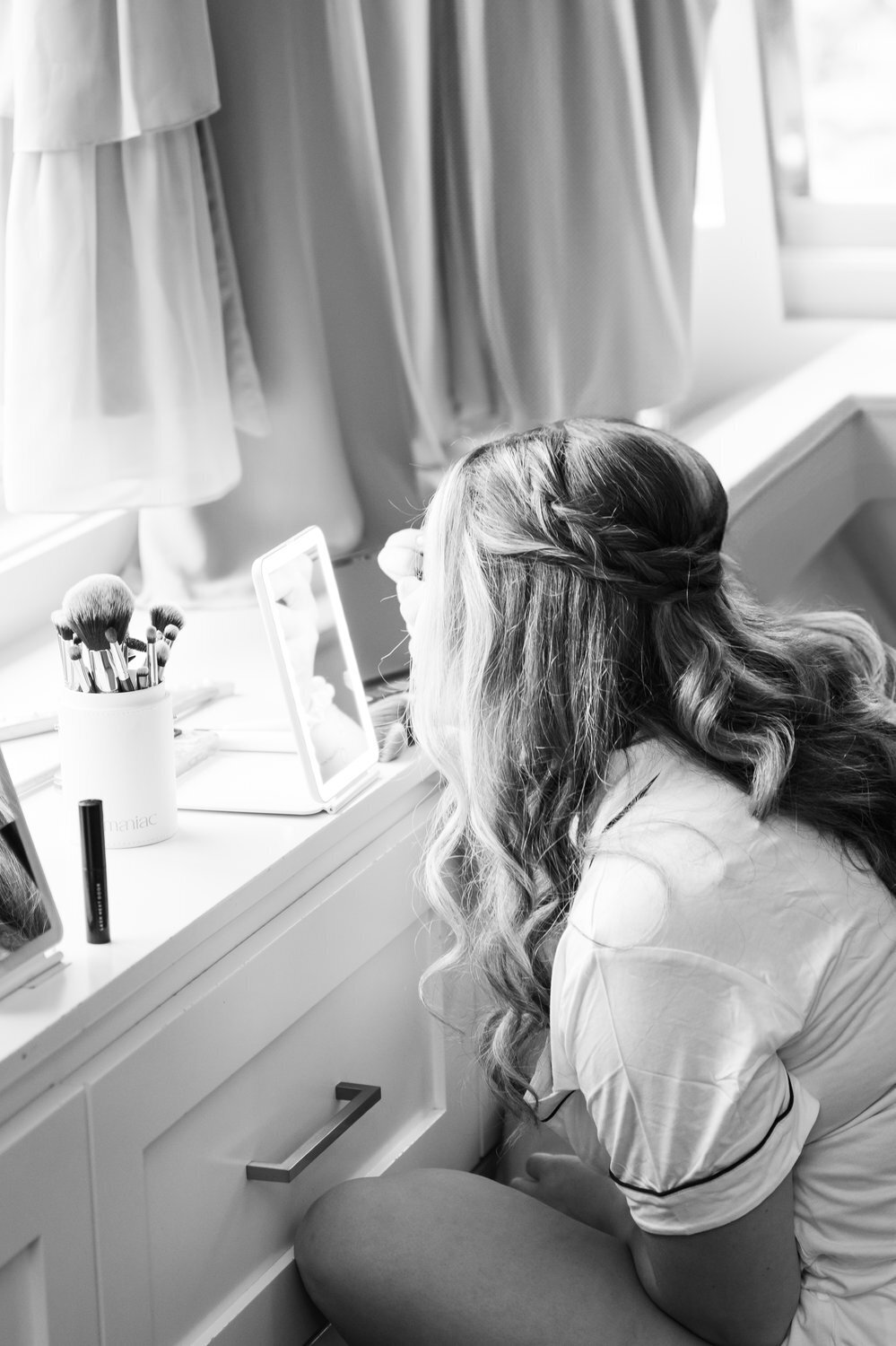 black and white image bride getting ready makeup and hair wedding morning