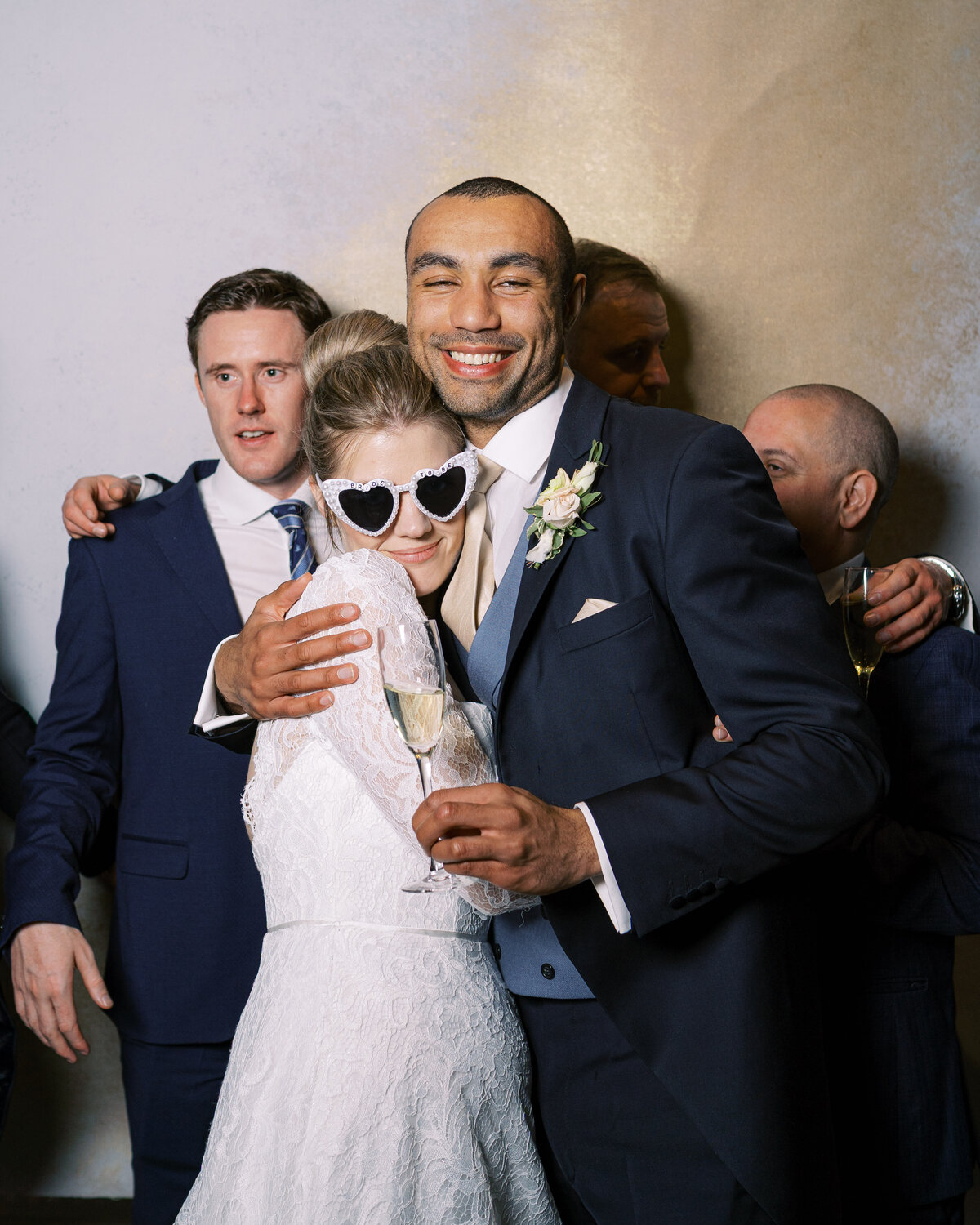 Bride and groomsmen in wedding portrait studio wedding photobooth