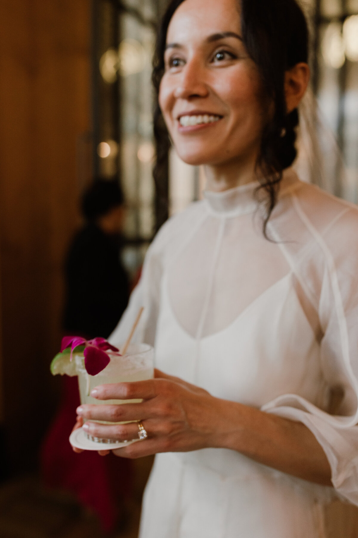 Bride holding cocktail at intimate wedding in Austin, TX