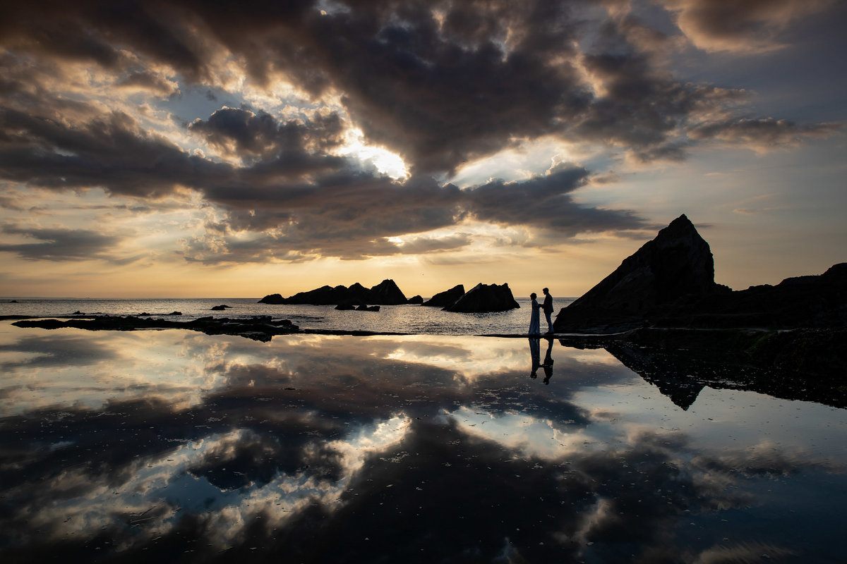 Silhouette of Bride & Groom at the end of their wedding day at Tunnels Beaches Devon Wedding Venue