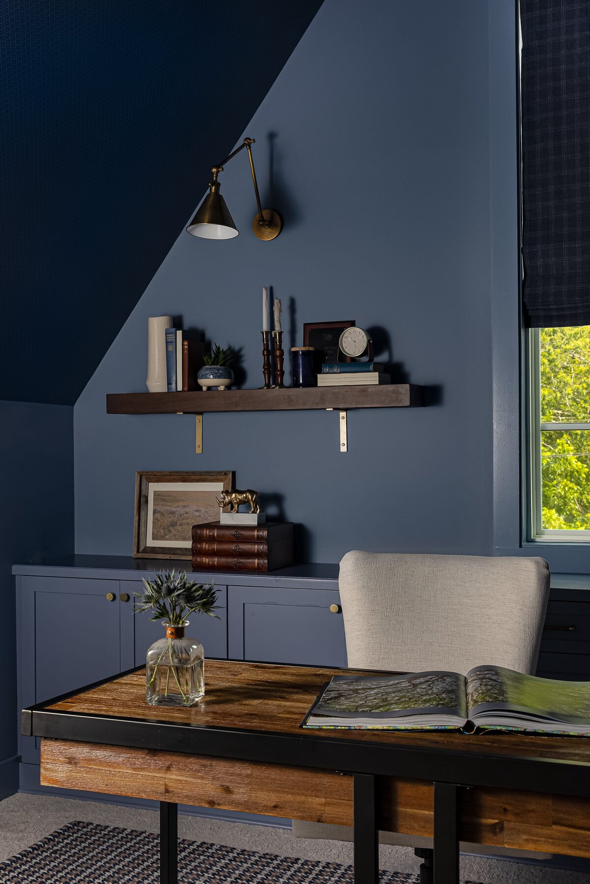 melinda chesson interiors everett place moody blue office with wood floating shelves on wall