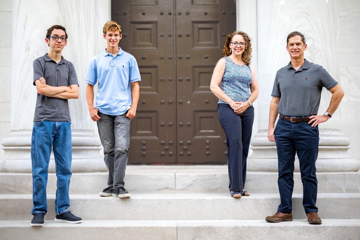 Parents pose with their teen sons on the steps of a histpric building in downtown Huntsville in Alabama