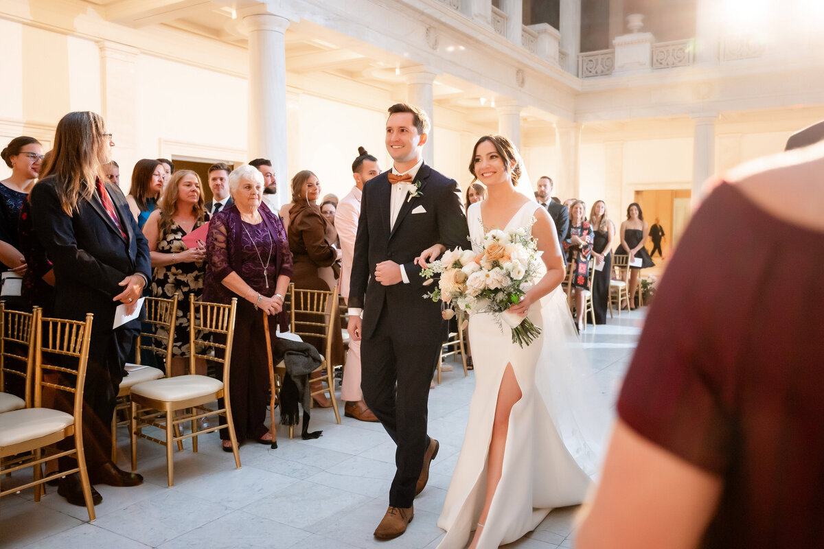 wedding reception in hall of sculpture bride walking down the aisle