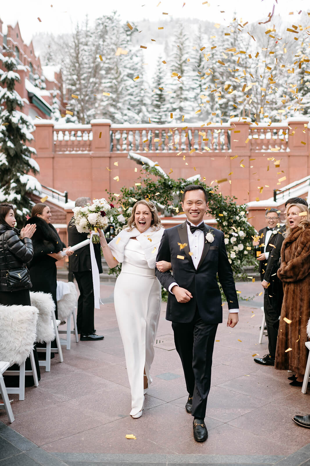 Bride and Groom walk down the aisle arm in arm at the conclusion of their wedding ceremony at the Aspen St. Regis.