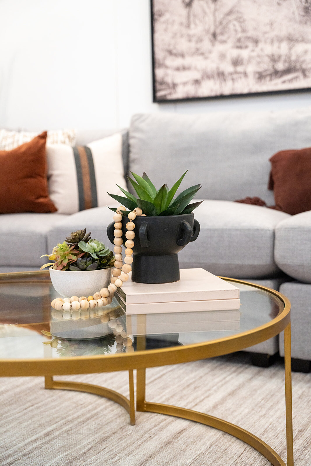 grey couch with red accents and coffee table accessory closeup