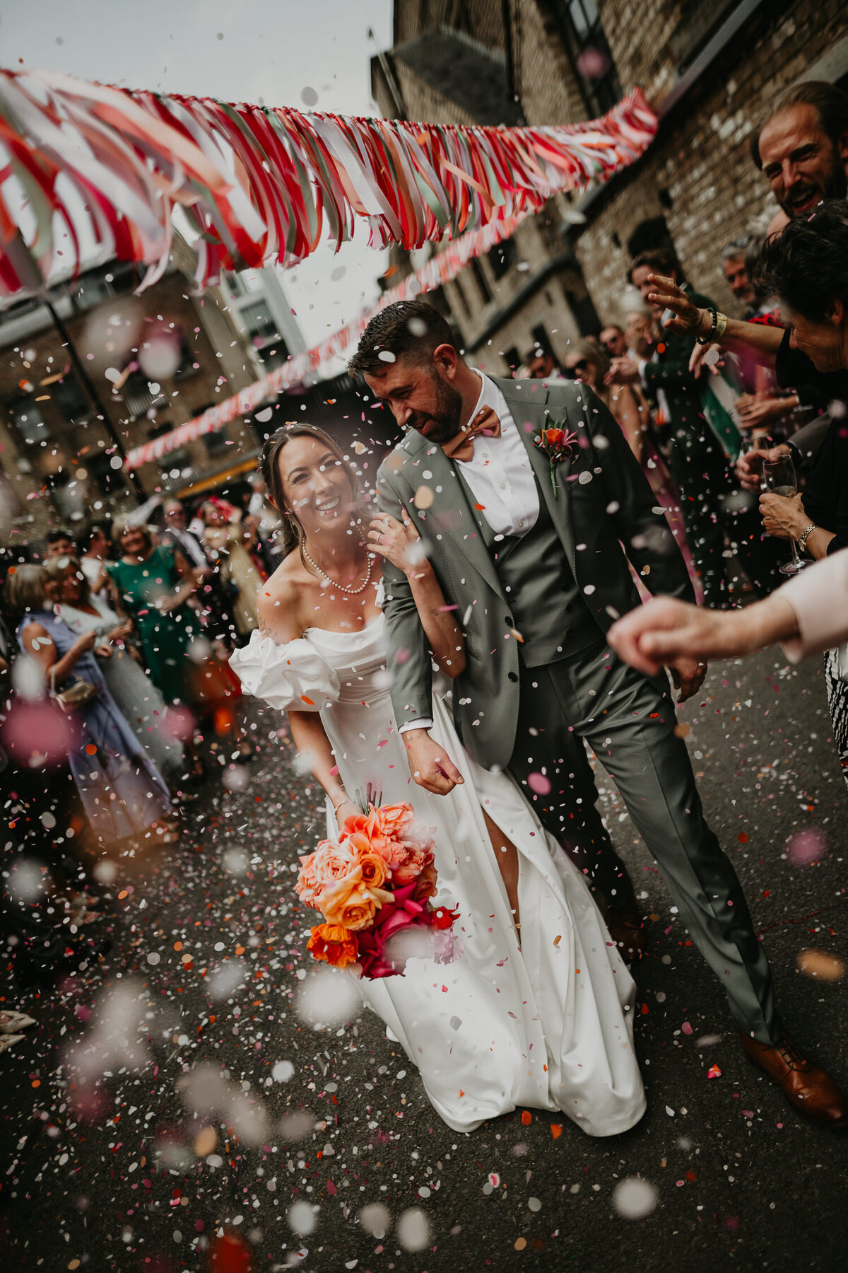 Bride and groom are showered in confetti as they walk into Shoreditch Studios. 