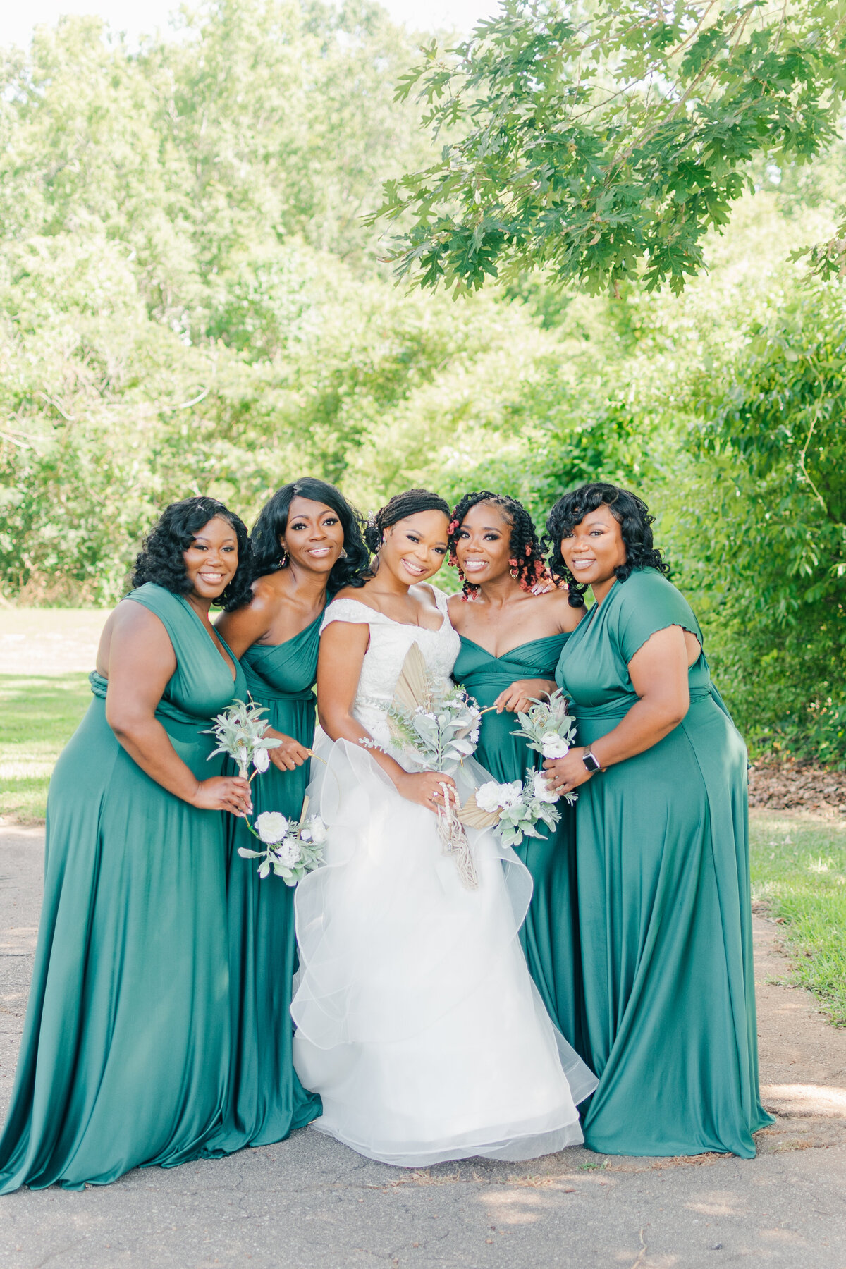 bride and her bridesmaids smiling on her wedding day in wilmington, nc