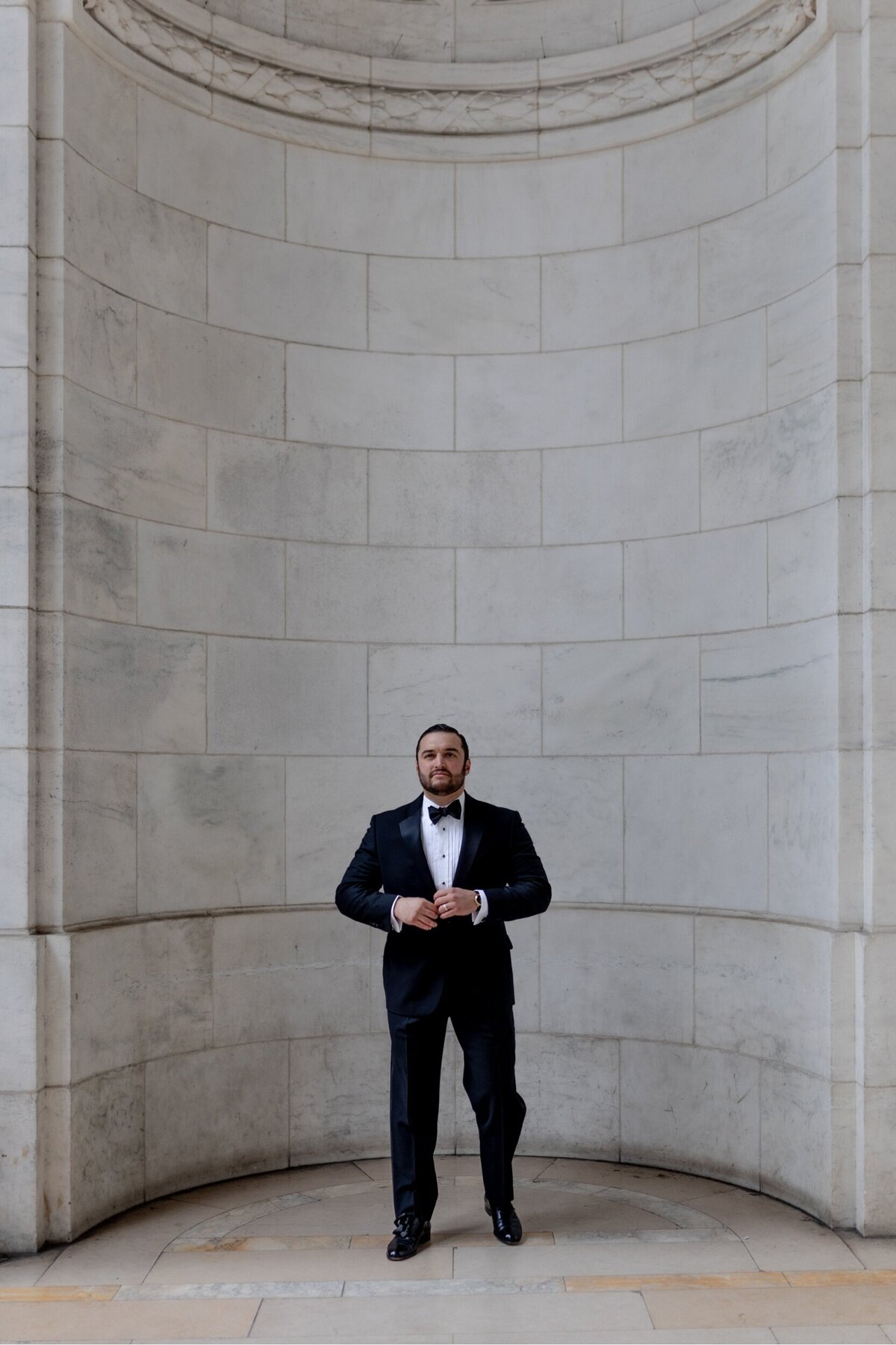 Groom posing for a photo after his wedding.