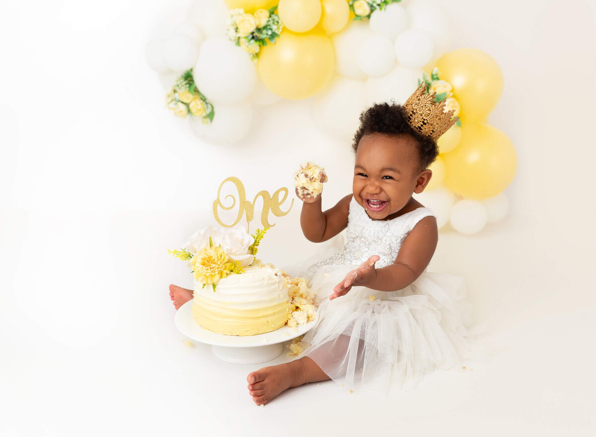 Yellow and white balloon garland girl cake smash session