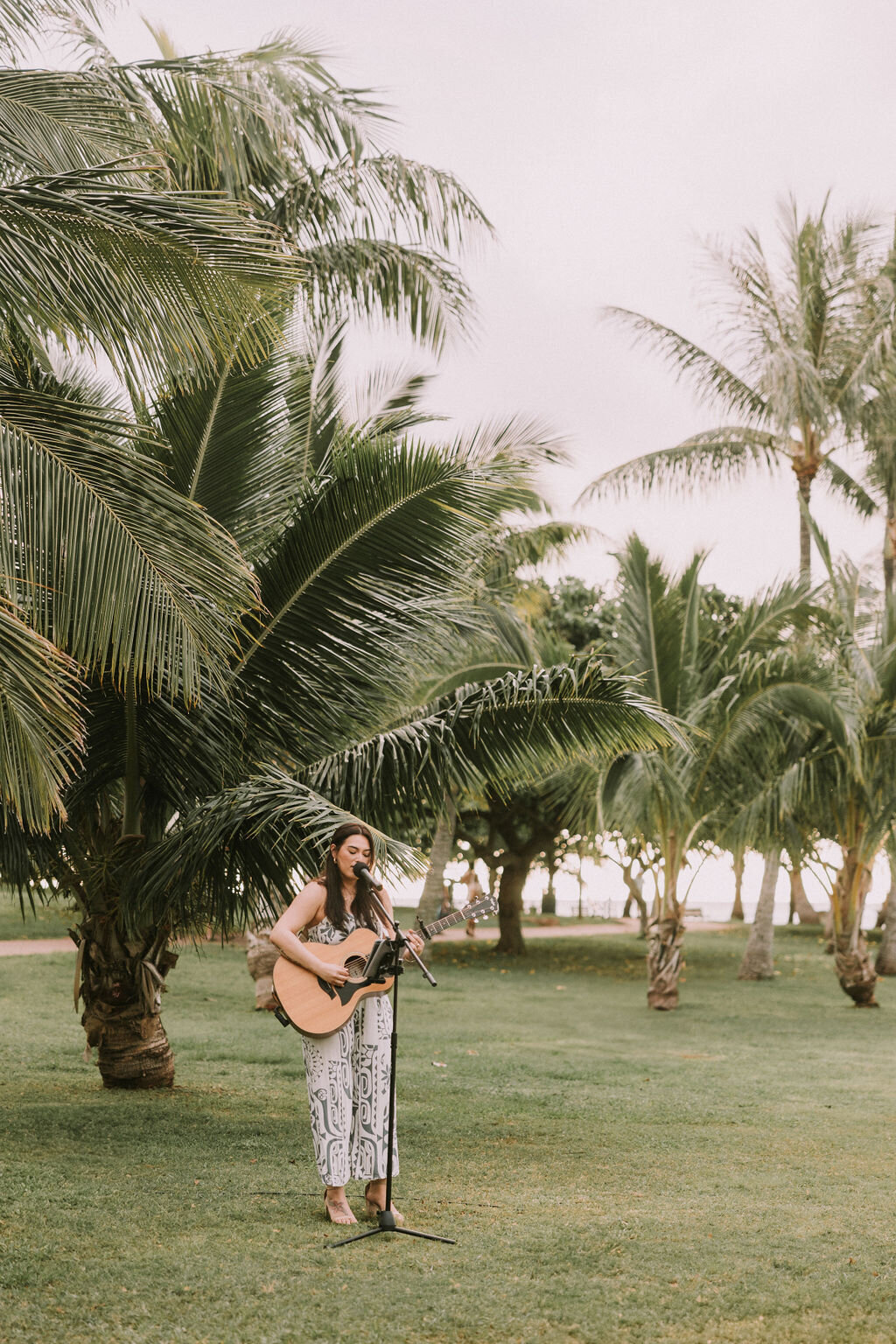 guitar player performing live music at the park for wedding welcome dinner