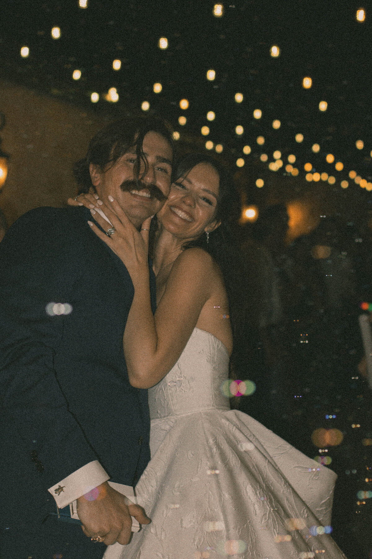 bride and groom wedding exit posed photo with film-like edit