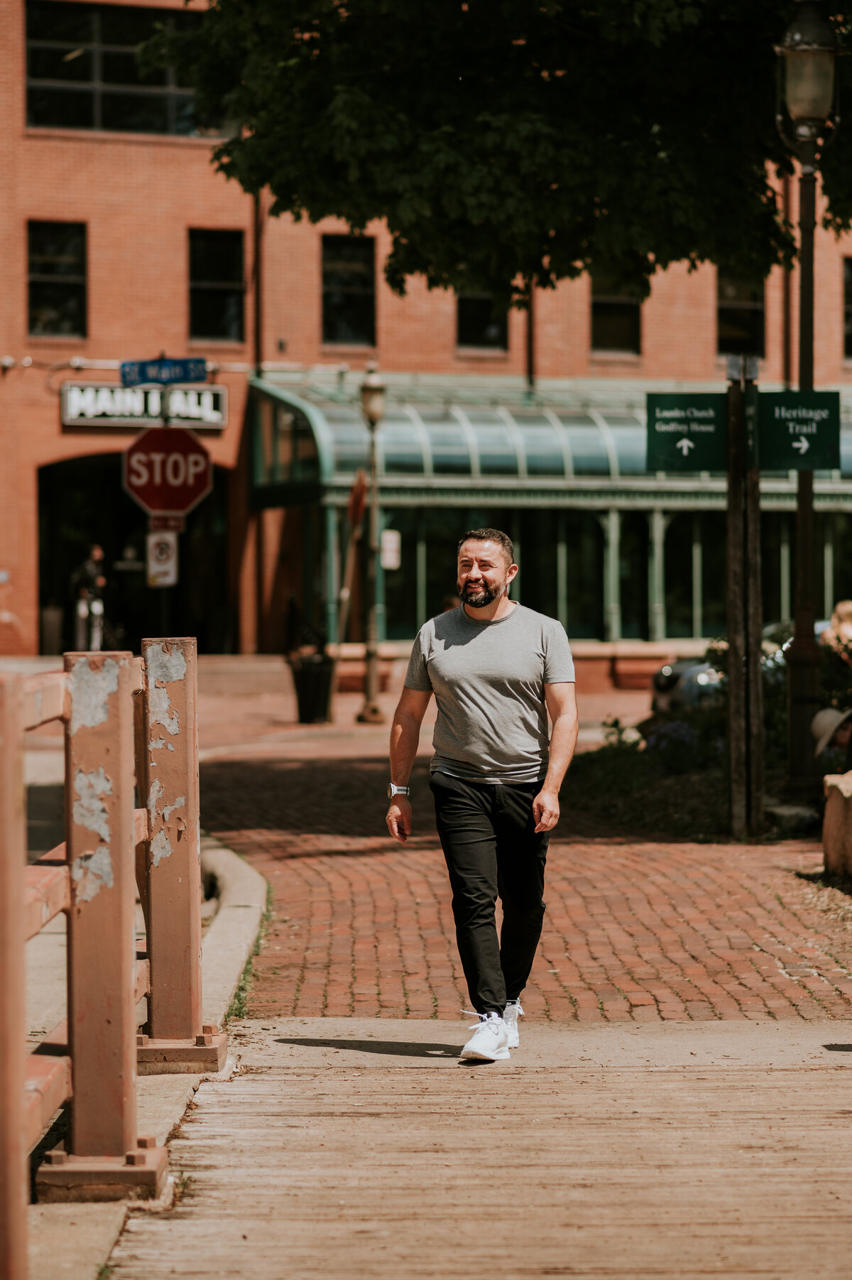 Urban lifestyle dating profile photo of a man walking through downtown Minneapolis, showcasing style and personality for modern dating apps.