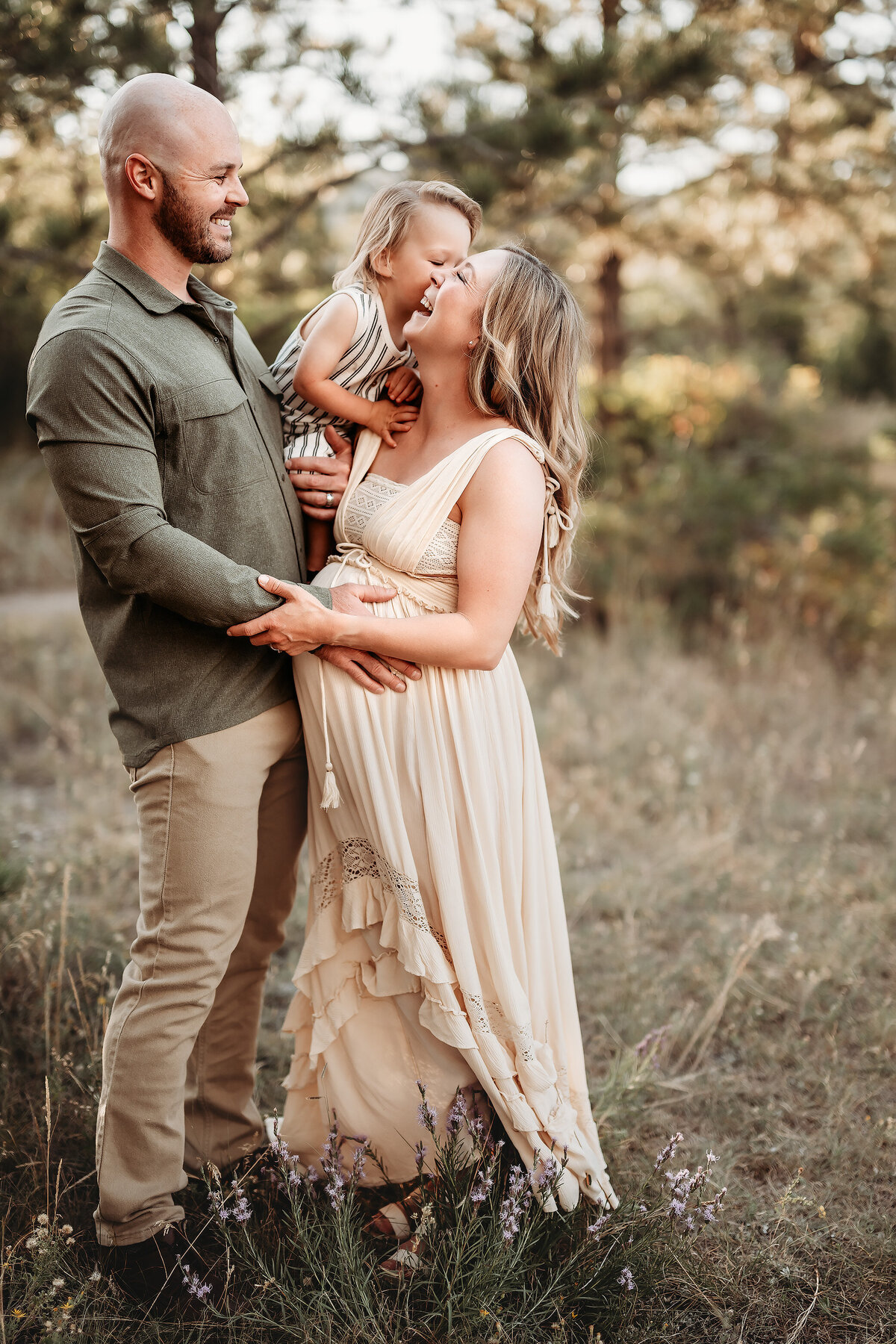 dad holding boy while he kisses mom