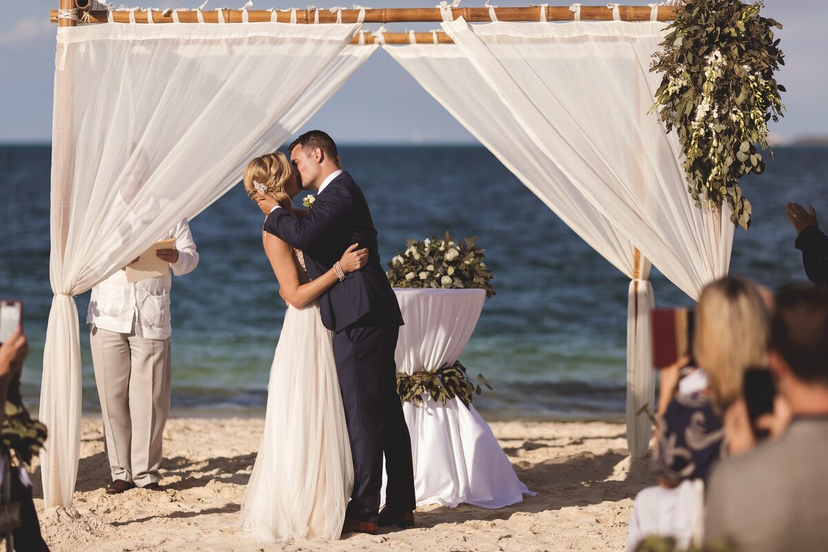 Bride and grooms first kiss at wedding in Cancun